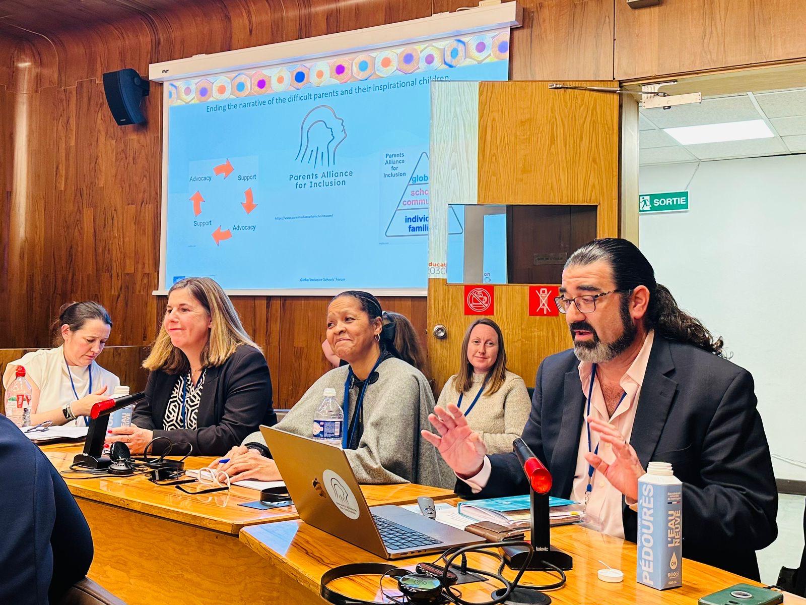 IFIP Parents picture two hands up Jon Springer speaking as part of a panel at the IFIP-UNESCO Global Inclusive Schools' Forum 14 March 2024.